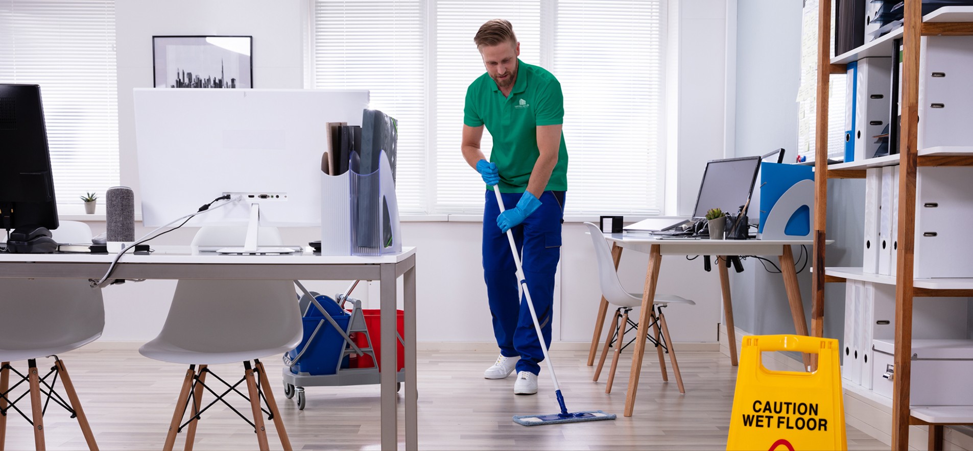 Photo of a Level Seven janitorial worker mopping an office floor